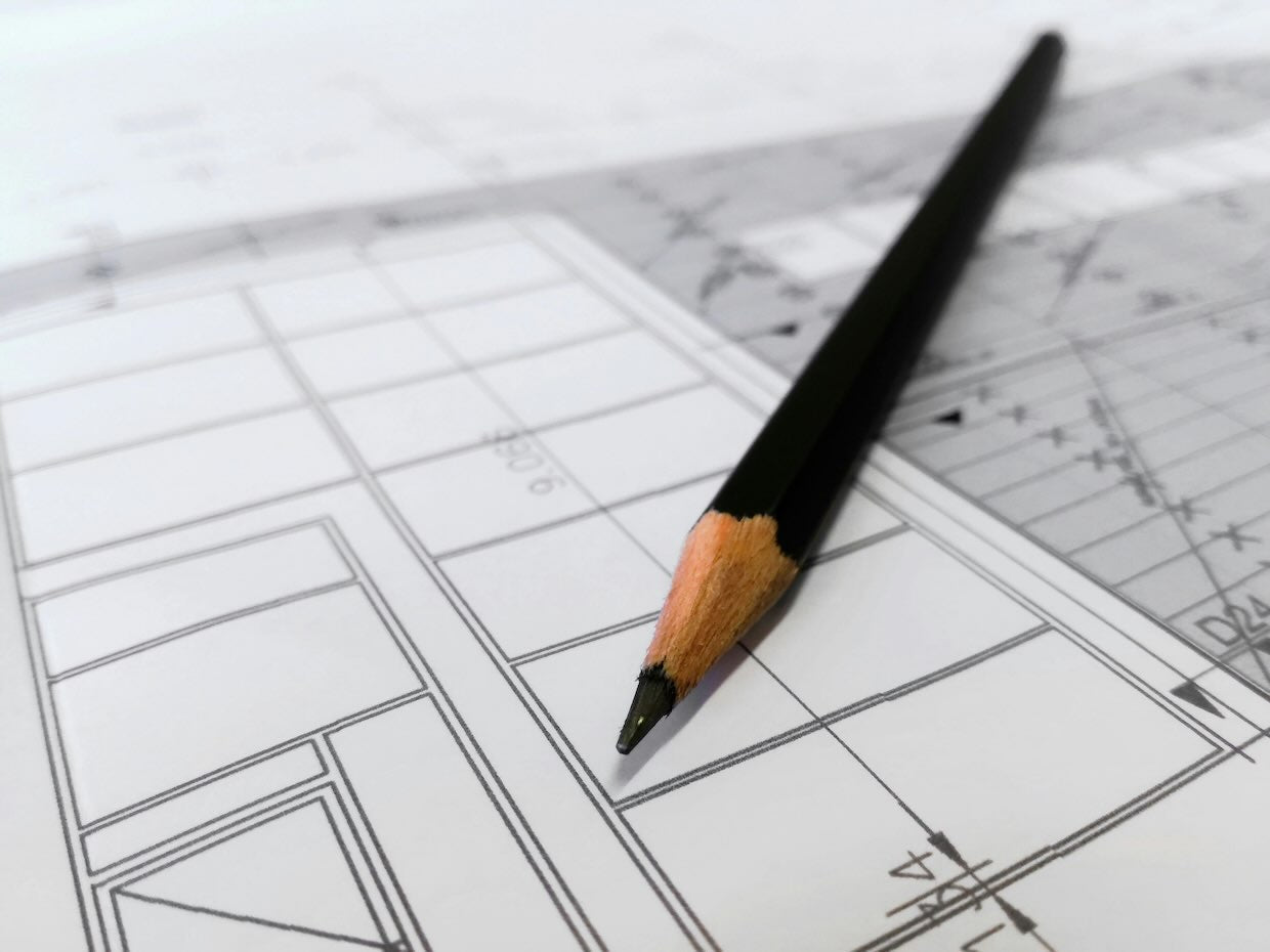 design concept image - pencil on blueprints